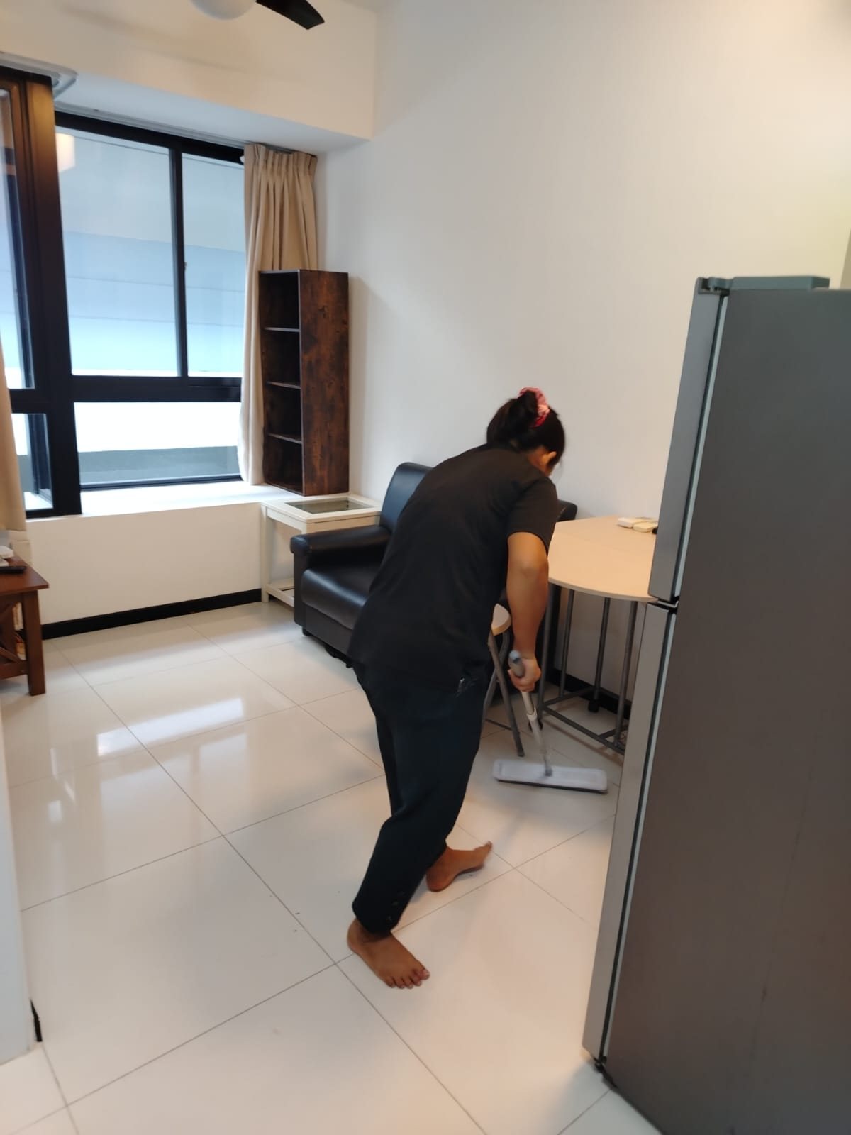Home cleaner mopping a living area